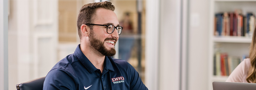DBU student smiling in library