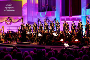 The choir captivates a large audience with their harmonious melodies