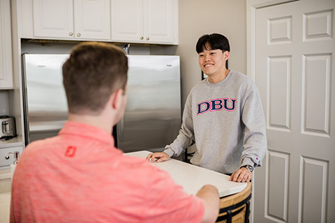 Residence Life guy college students talking in Stone House in the Ford Village