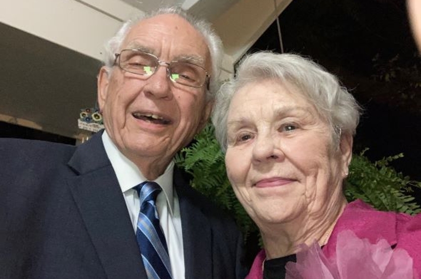 Dr. Wade and his wife Rosemary dressed formally, with Dr. Wade in a suit and Rosemary in a pink.