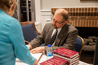 dr mitchell signs books