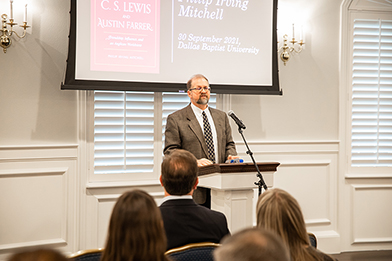 dr mitchell speaks in front of audience