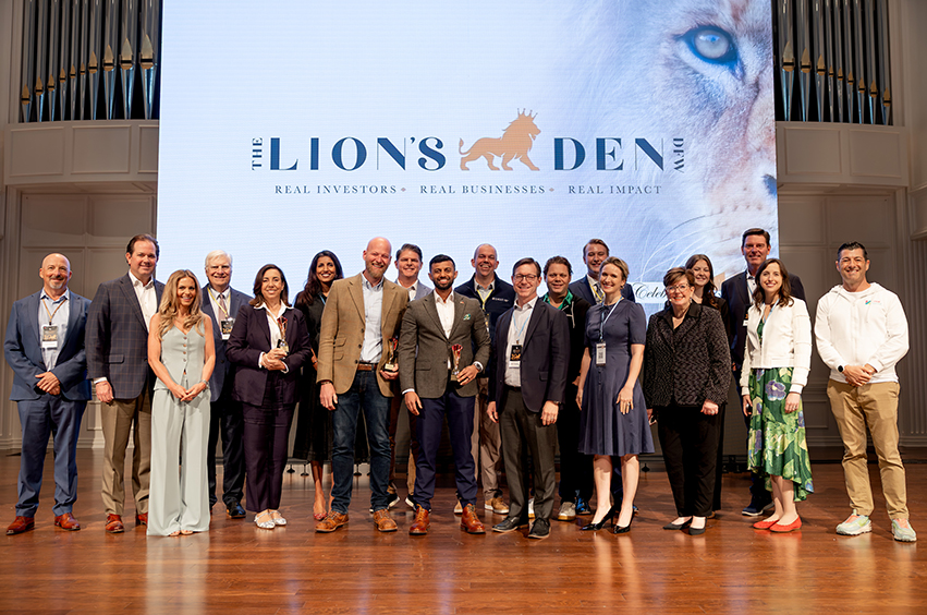 group of people standing on the stage of the Pilgrim chapel for Lion's Den event in Dallas, Texas