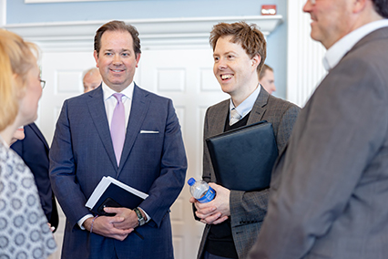 DBU President Dr. Adam C. Wright chatting amongst peers