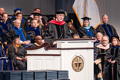 Dr. Mackey speaking at DBU during the spring commencement service